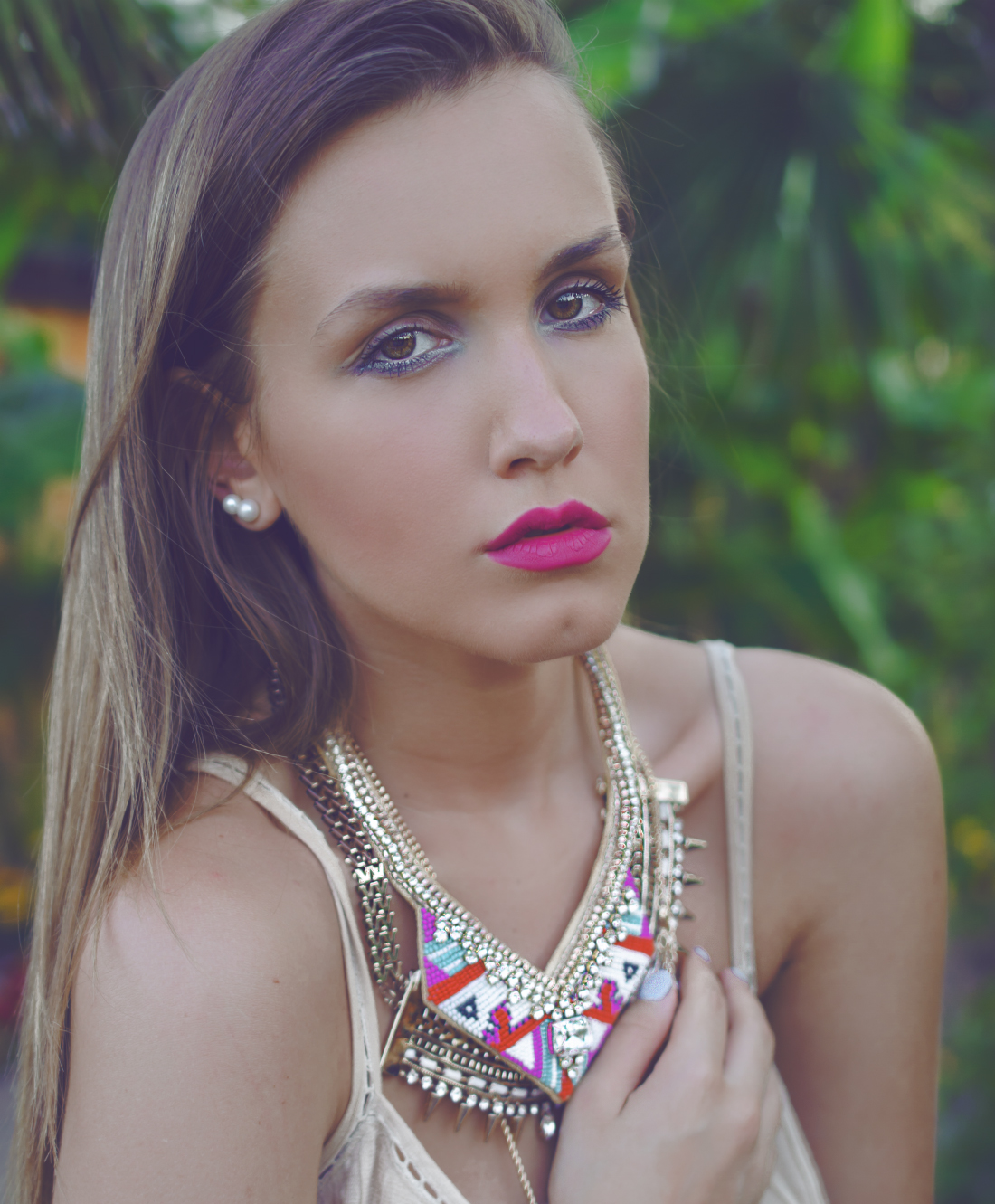 colorful make up and layered statement necklaces